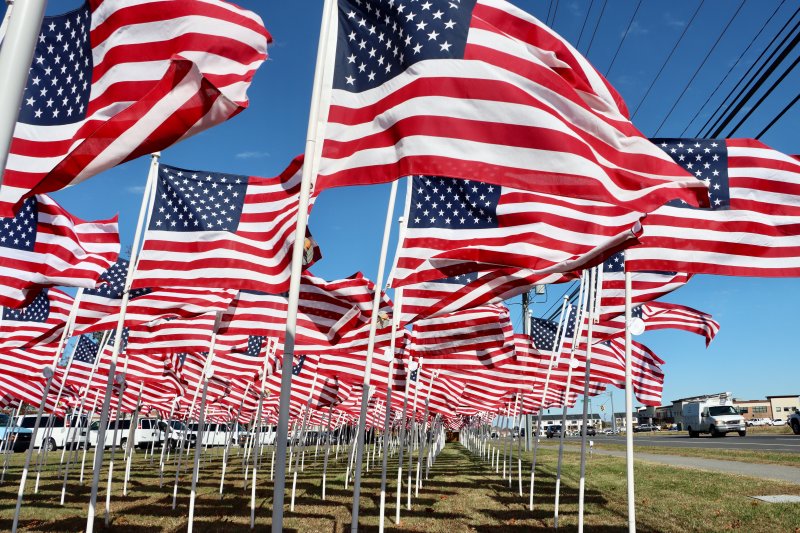 While the ceremony was held indoors, 550 American flags flew in the wind outside the high school along Kings Highway. The Rotary sold medallions for $50 apiece that were attached to the flags in honor of a loved one who served.